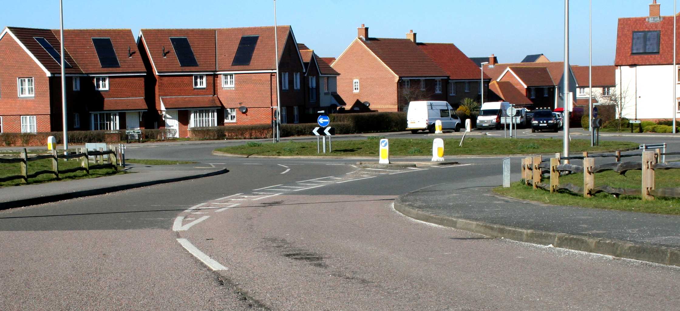 Potholes at a rat run braking area with multiple repairs